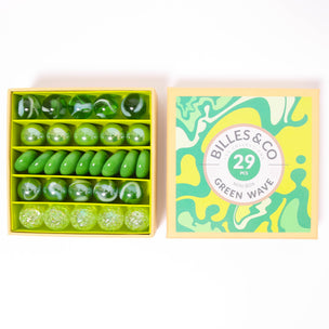 A great selection of various green glass marbles and pebbles in a themed box | © Conscious Craft