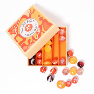 A great selection of various orange glass marbles and pebbles in a orange themed box | © Conscious Craft