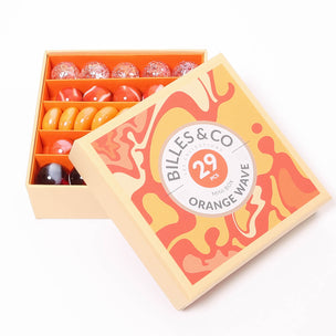 A great selection of various orange glass marbles and pebbles in a orange themed box | © Conscious Craft