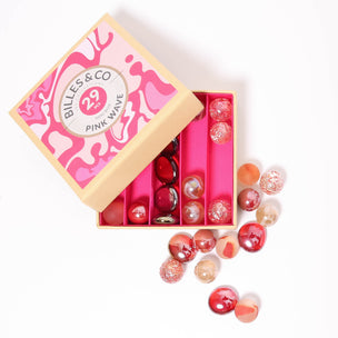 A great selection of various pink glass marbles and pebbles in a pink themed box | © Conscious Craft