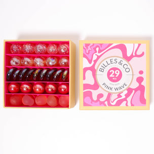 A great selection of 29 pink glass marbles and pebbles in a pink themed box | © Conscious Craft