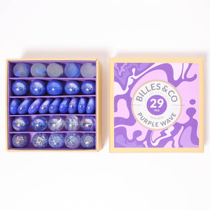 A great selection of 29 purple glass marbles and pebbles in a purple themed box | © Conscious Craft