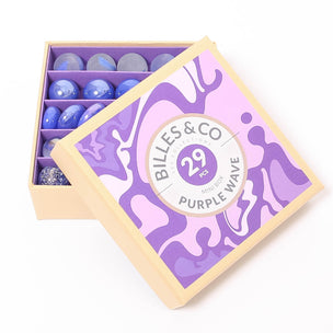 A great selection of various purple glass marbles and pebbles in a purple themed box | © Conscious Craft