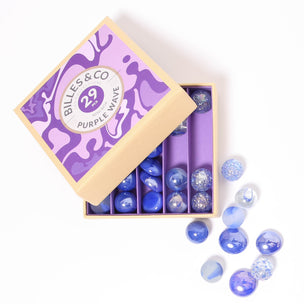 A great selection of various purple glass marbles and pebbles in a purple themed box | © Conscious Craft