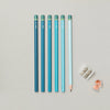 Set of blue pencils with a sharpener on a light gray background