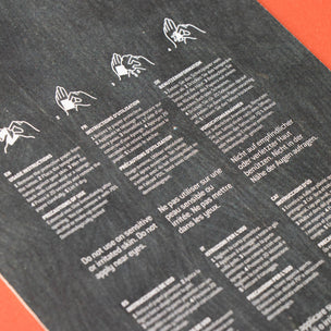 Instructions or guidelines printed on a black surface with white text and icons.