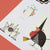 Halloween-themed cutout decorations including a witch, spider, and ghost on a red background.
