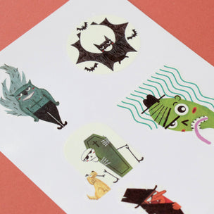 Set of Halloween-themed temporary tattoos on a white card with a red background