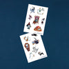 Two sheets of Halloween-themed temporary tattoos on a dark blue background