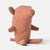 A plush stuffed Maileg animal pig in a dusty rose color, photographed from a side-back angle on a clean, light gray studio background.