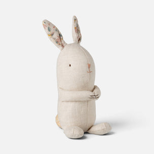 A cream-colored linen stuffed bunny plush toy with patterned floral ears, sitting against a light gray background.
