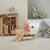 Children's room with toy furniture and plush toys including a elephant, bear, and pig.