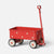 A red metal Maileg toy wagon with white polka dots, black tires, and a red handle, photographed on a clean light gray background.