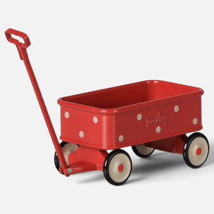 A red metal Mtoy wagon with white polka dots, cream-colored wheels, and a red handle, shown on a light gray background.ileg 