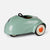 A retro-style pedal toy car in a glossy mint green color, featuring cream-colored wheels with orange centers and a black steering wheel, shown on a light gray background.