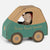 A small Maileg mouse toy sitting inside a cardboard car-shaped box labeled 'Santa's Parcel Service' in teal and tan, on a light gray background.