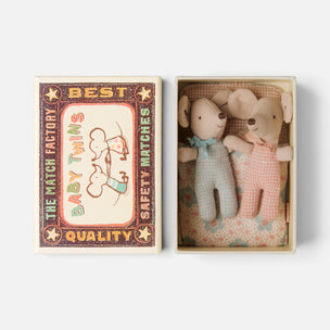 A matchbox-style gift set shown open on a light gray background. The left side shows the decorative matchbox lid with vintage-style text reading 'BEST BABY TWINS SAFETY MATCHES' and 'THE MATCH FACTORY QUALITY.