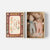 A matchbox-style gift set shown open on a light gray background. The left side shows the decorative matchbox lid with vintage-style text reading 'BEST BABY TWINS SAFETY MATCHES' and 'THE MATCH FACTORY QUALITY.