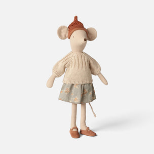 A Maileg mouse doll with a cream knit sweater, a floral skirt, and a brown knit hat, standing against a light gray background.