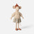 A Maileg mouse doll with a cream knit sweater, a floral skirt, and a brown knit hat, standing against a light gray background.