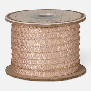 A spool of rose gold glitter ribbon wound on a cardboard core, shown against a plain light gray background.