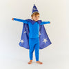 Child wearing a Sara's Silks blue wizard Merlin costume with a cape and hat on a white background