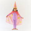 Sarah's Silks Child wearing a pink superhero costume with cape and hat on a white background