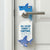 A novelty door hanger featuring a shark design and the text 'ALL CLEAR! SHARK'S NAPTIME' is shown hanging from a silver metal doormat handle on a white paneled door.