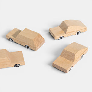 Set of wooden toy cars on a white background
