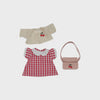 Children's outfit with red checkered shirt, beige jacket, and pink bag on a light gray background