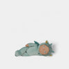 Baby figurine wearing a green outfit on a white background