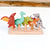 Set of colorful dinosaur figurines on a wooden stand with a wooden background