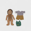 Plush doll with brown outfit, striped shirt, shorts, and green backpack on a white background