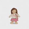 Doll wearing a cream jacket with cherry design, red checkered skirt, and pink bag on a white background
