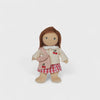 Toy doll with a jacket and skirt on a white background