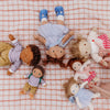 Collection of dolls on a checkered fabric surface