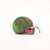 A 3D cardboard DIY model of a snail, constructed with layered wooden slats, featuring a brown body, green head and ear, and pink and white stripes on the face, set against a plain white background.
