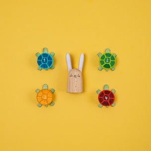 Wooden toy rabbit with number magnets on a yellow background