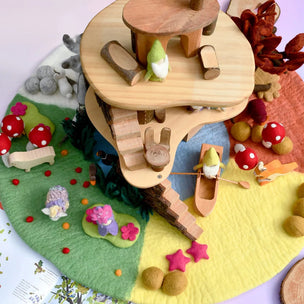Wooden toy with animal figures on a colorful felt background