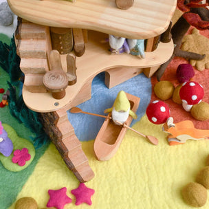 Wooden toy with a gnome and accessories on a colorful felt play mat