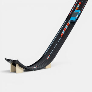 Toy race track with a car on a white background