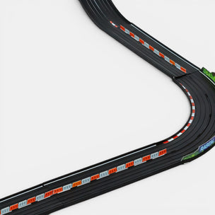 Model of a slot car racing track with a curved section on a white background