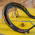Toy slot car track with cars on a yellow surface