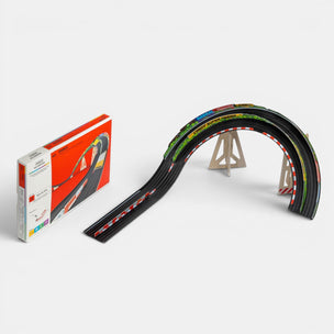 Toy race track set with a curved section and packaging on a white background