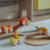 Wooden toy cars on a track set on a light-colored surface