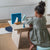 Child playing with toys at a small table in a kitchen