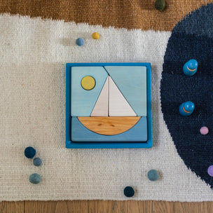 Wooden puzzle with a sailboat design on a textured surface