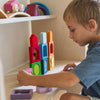 Child playing with colorful building blocks on a shelf