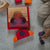 Child playing with wooden shape sorting toy on a carpeted floor