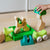 Child playing with wooden toy blocks on a light wood floor.